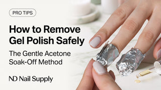 Overhead view of a woman removing her own gel polish at home with a gentle acetone foil soak-off — safe DIY removal, ND Nail Supply